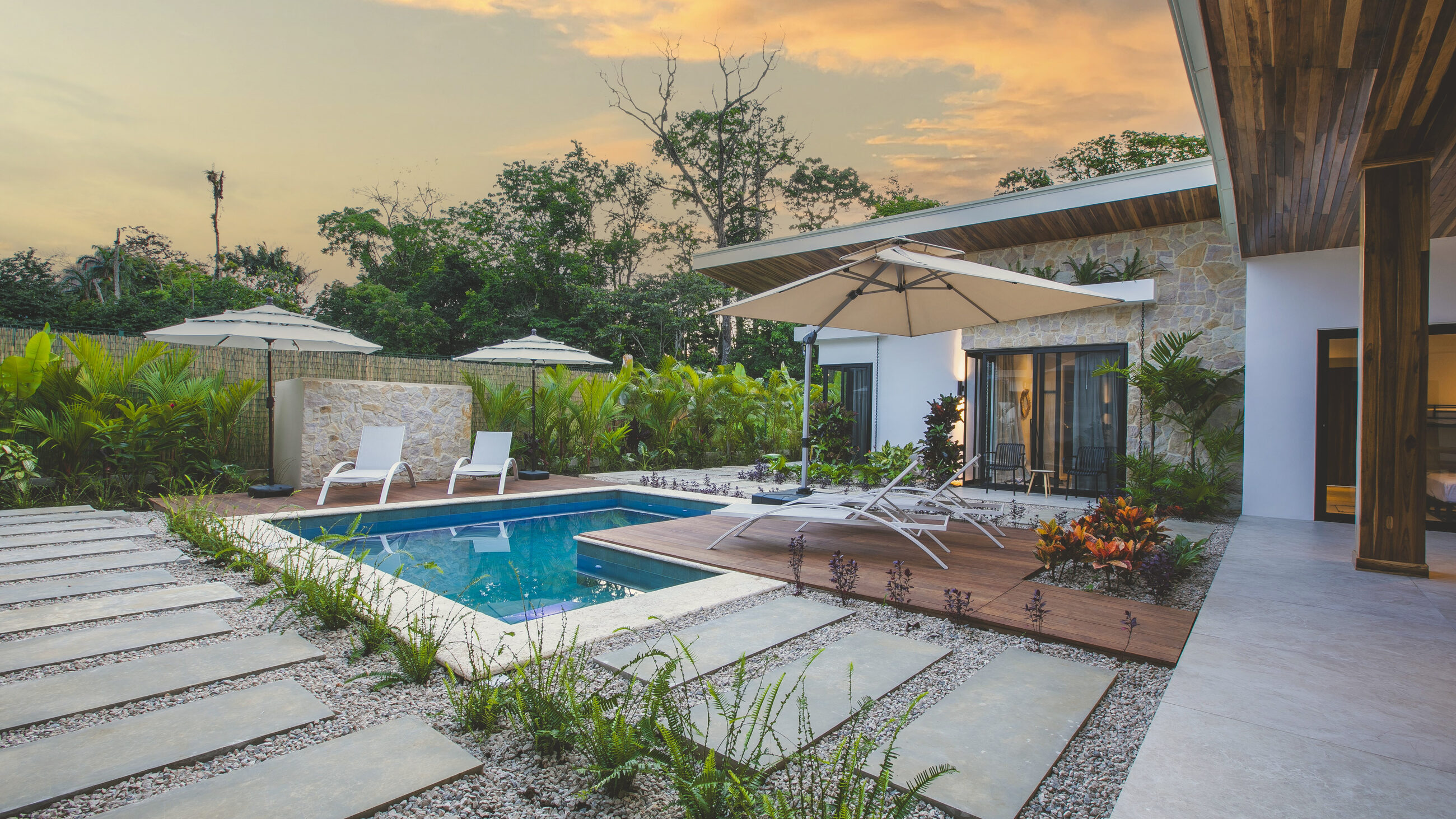 The pool and villa at dusk